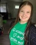 An Arbor Financial employee poses in her Stomp Out Stigma 5K t-shirt.