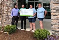 Our Caring Committee poses with staff from Unleashed Love Pet Rescue for a check presentation.